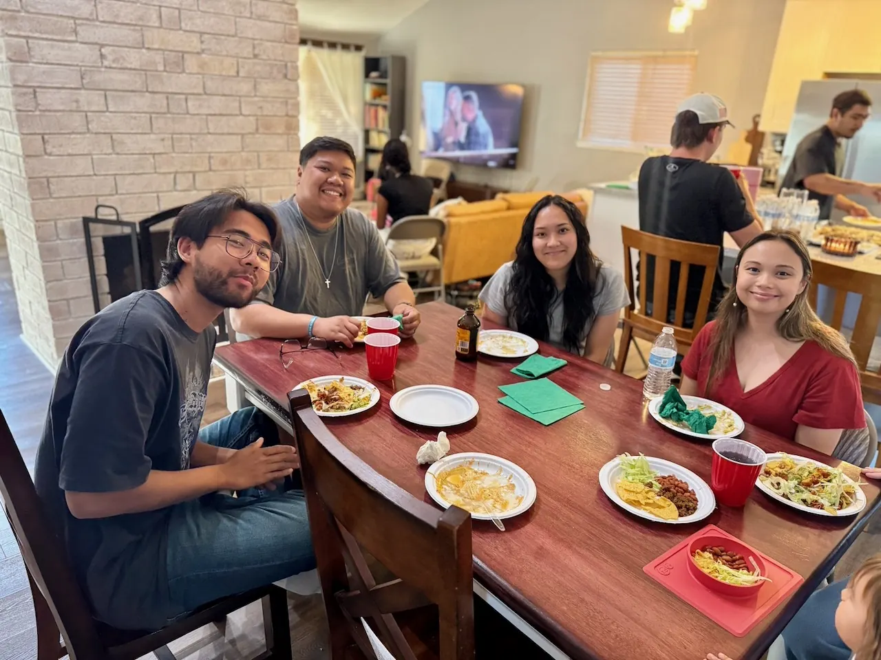 Young Adults gathering around a table